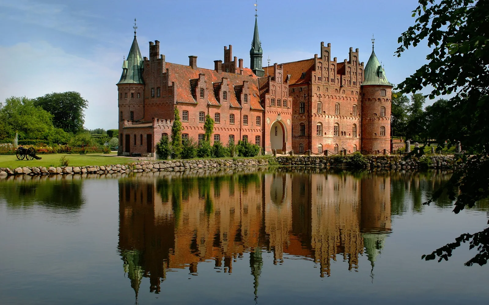 Egeskov Castle reflected in its surrounding lake