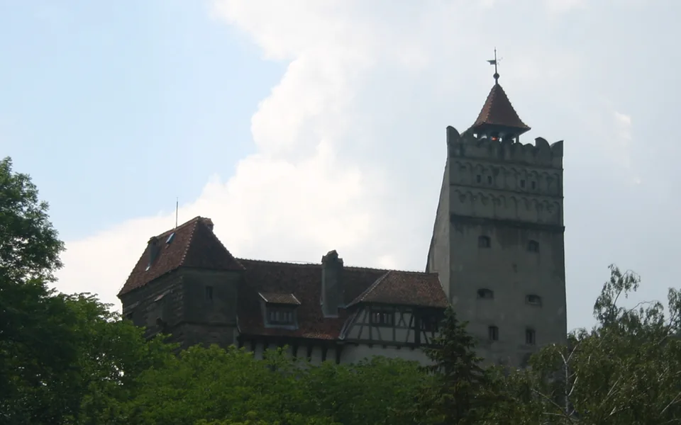 Bran Castle above its wooded Transylvanian setting