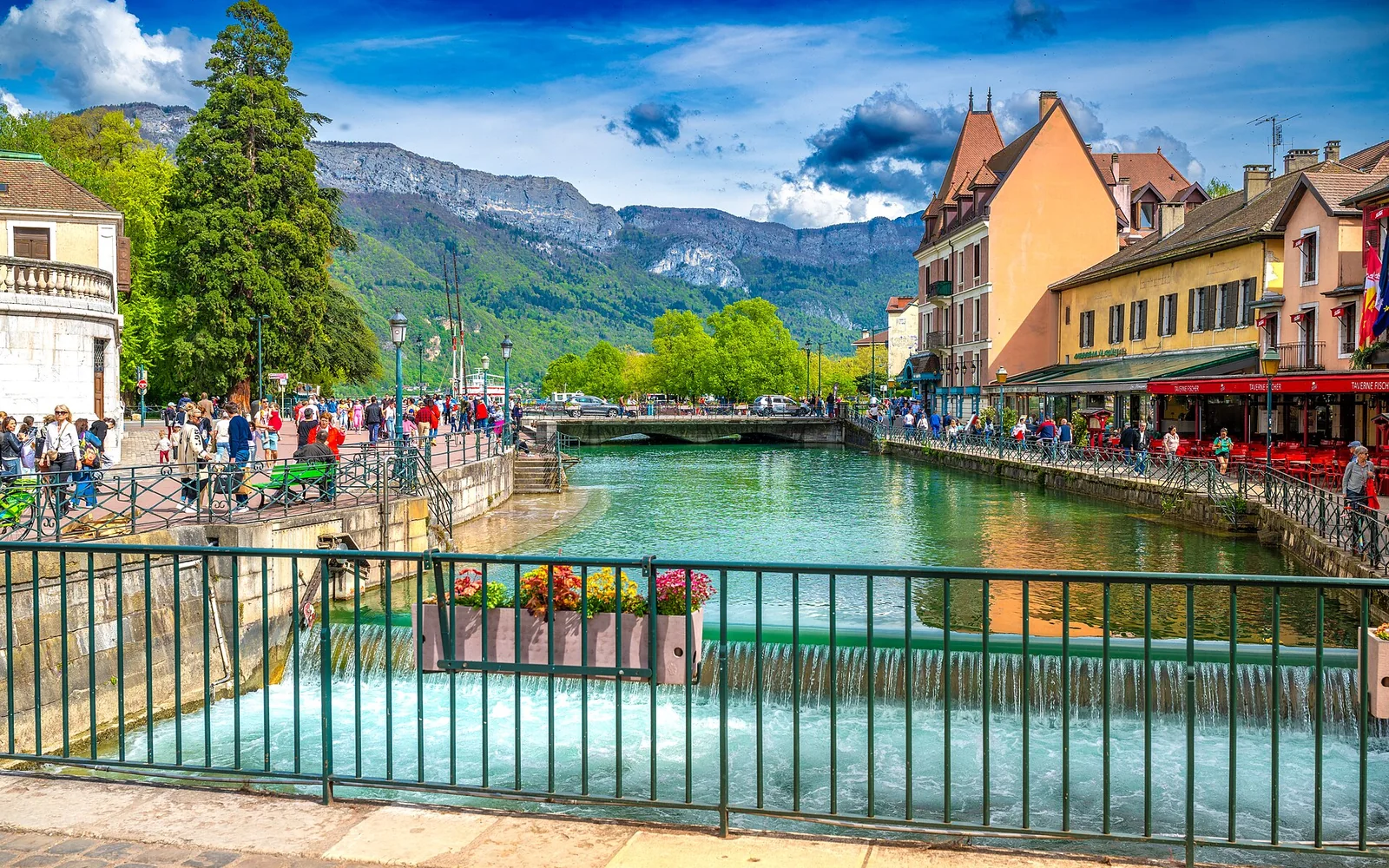 Annecy's old town canals with the Alps beyond
