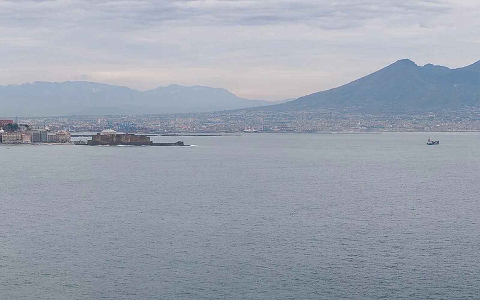 Naples beside its bay with Mount Vesuvius beyond
