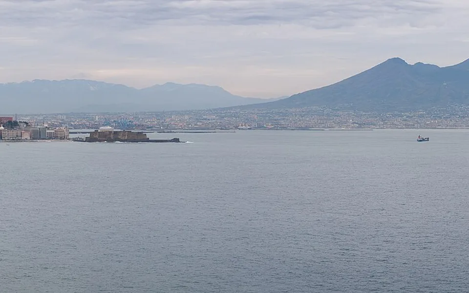 Naples beside its bay with Mount Vesuvius beyond