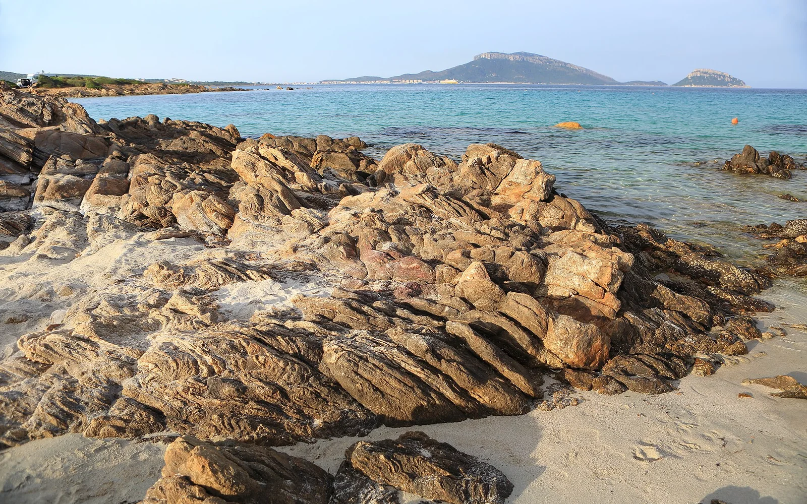 Rocky shore and clear water at Sos Aranzos beach in Sardinia