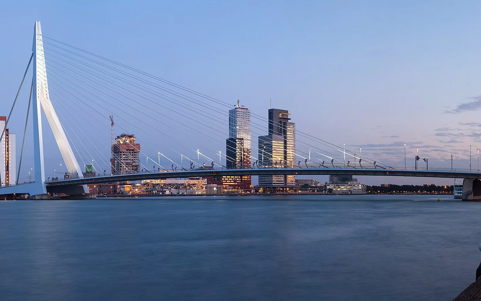 The Erasmus Bridge and Rotterdam skyline beside the Nieuwe Maas