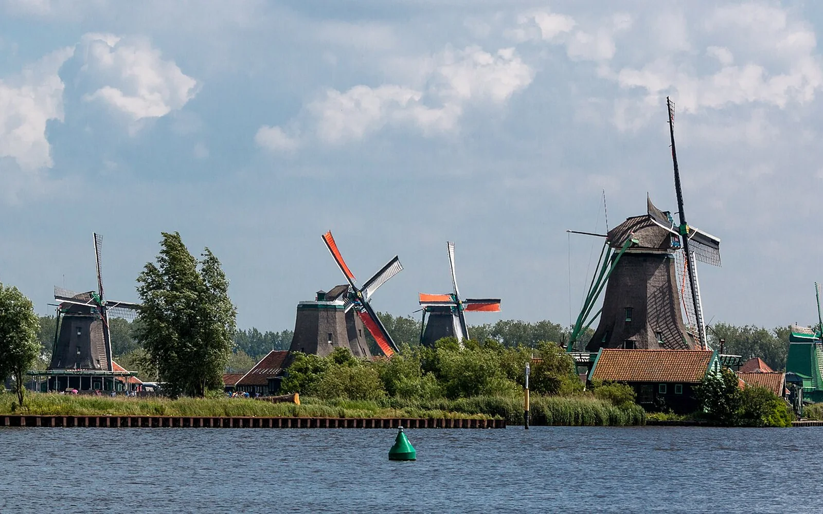 Windmills and green wooden buildings at Zaanse Schans