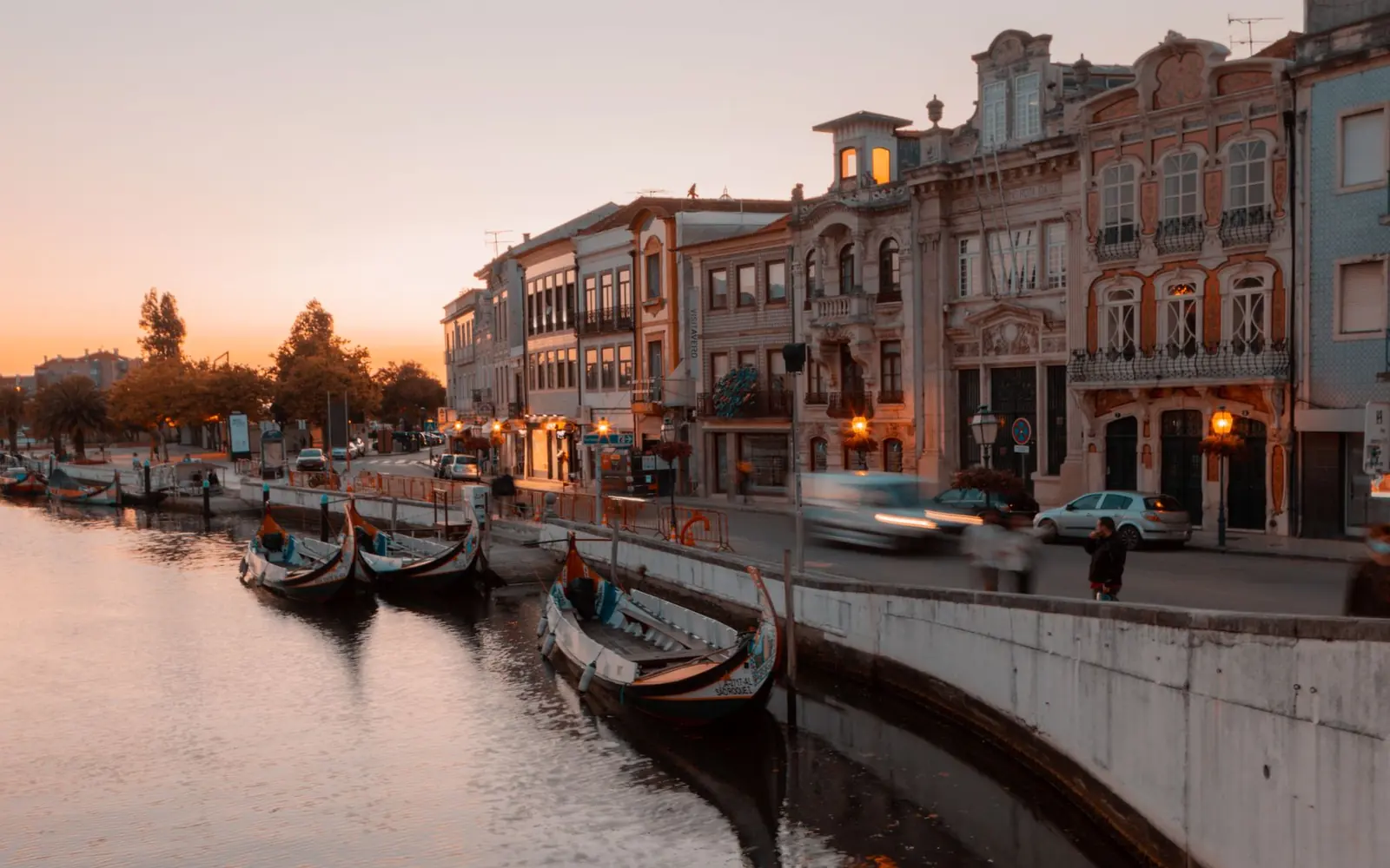 Moliceiro boats on a canal in central Aveiro at sunset