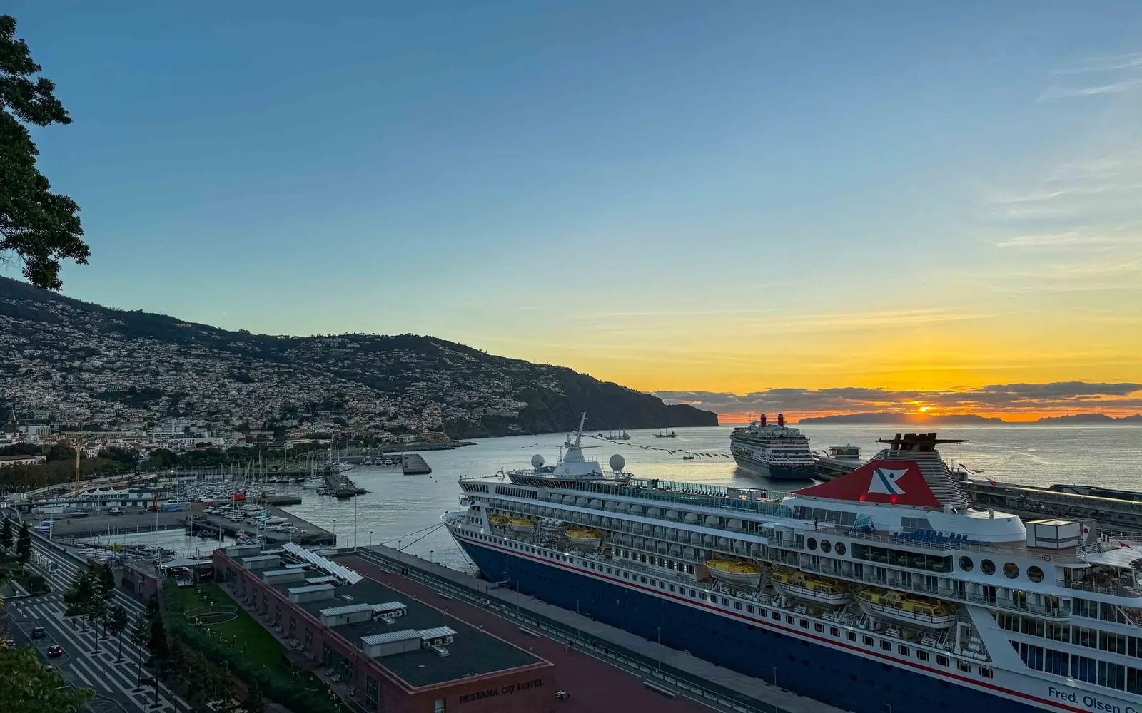 Funchal harbour and hillside neighbourhoods at sunset