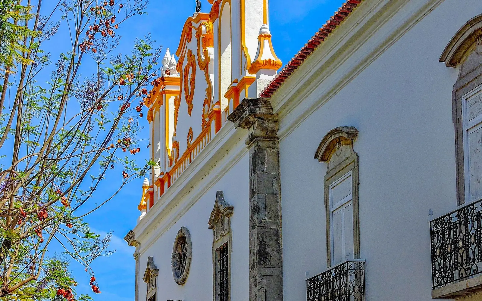 White historic church with decorative roofline in Tavira