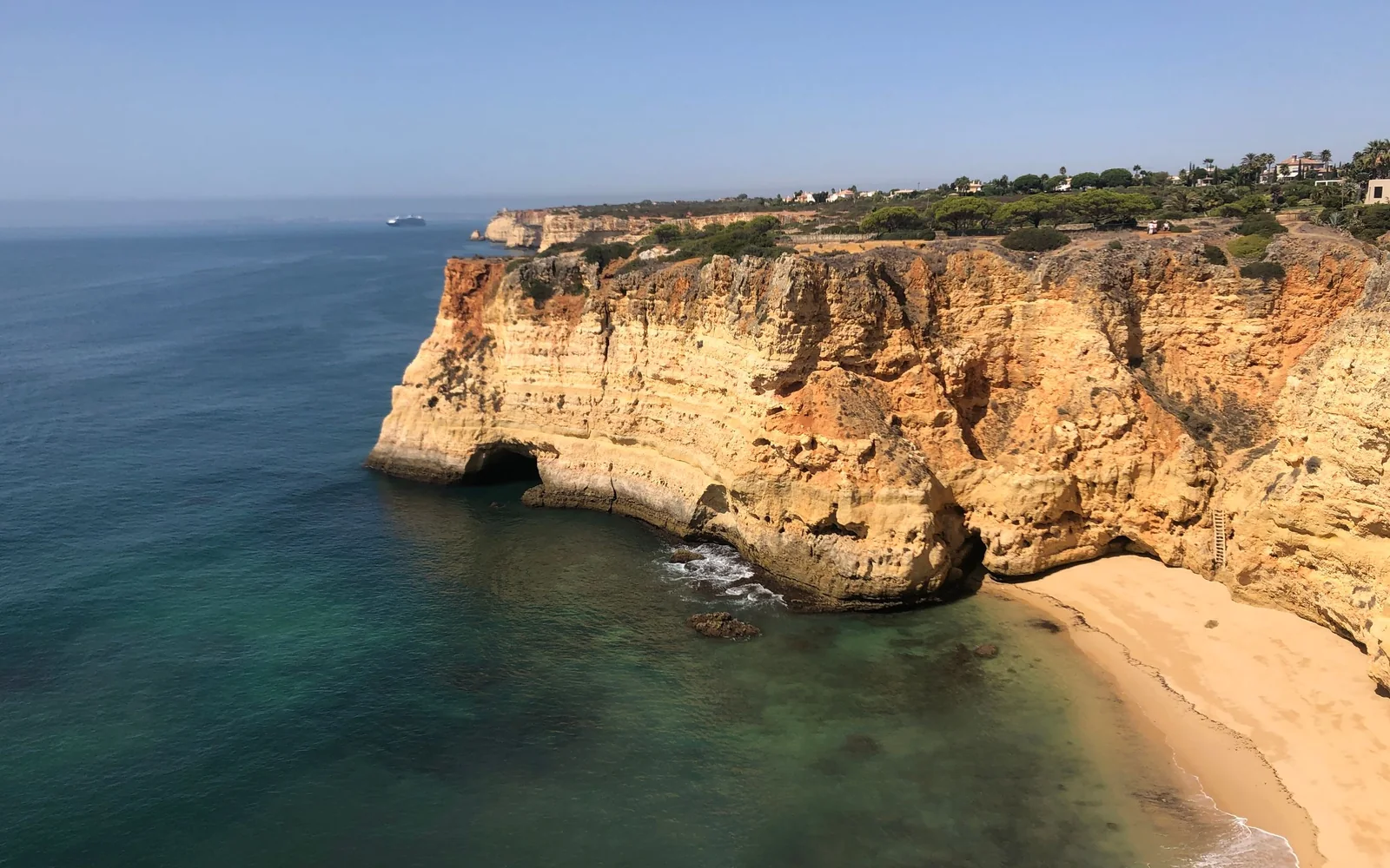 Golden cliffs and a small beach on the Algarve coast