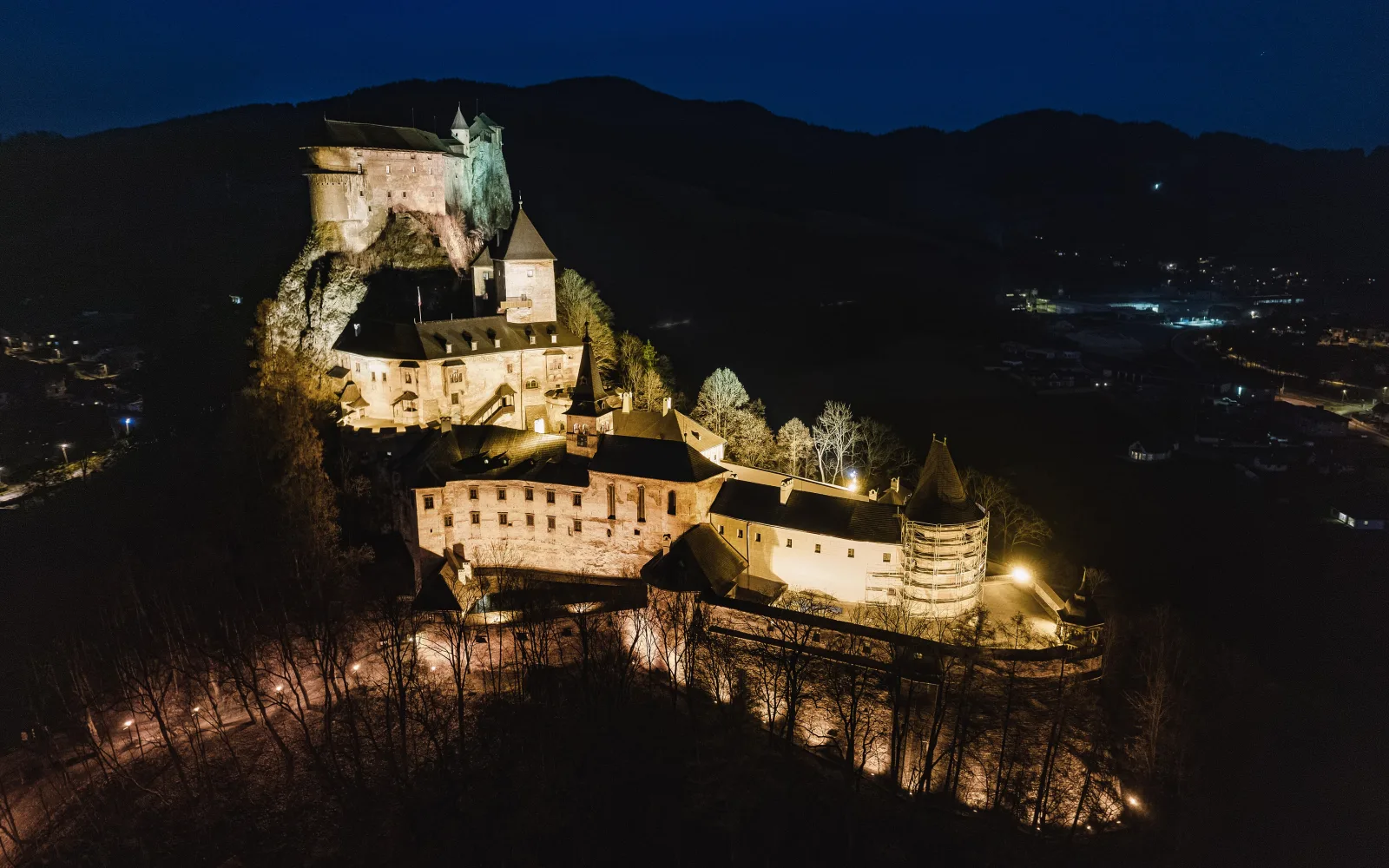 Orava Castle illuminated above Oravský Podzámok at night